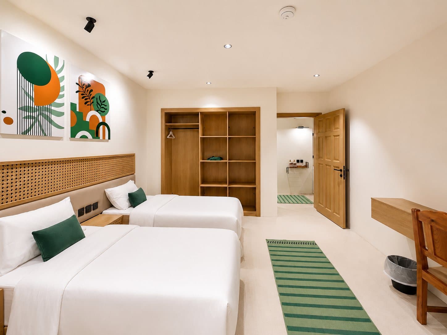 A twin room with an open wardrobe and warm wood — Ibn Khaldun
